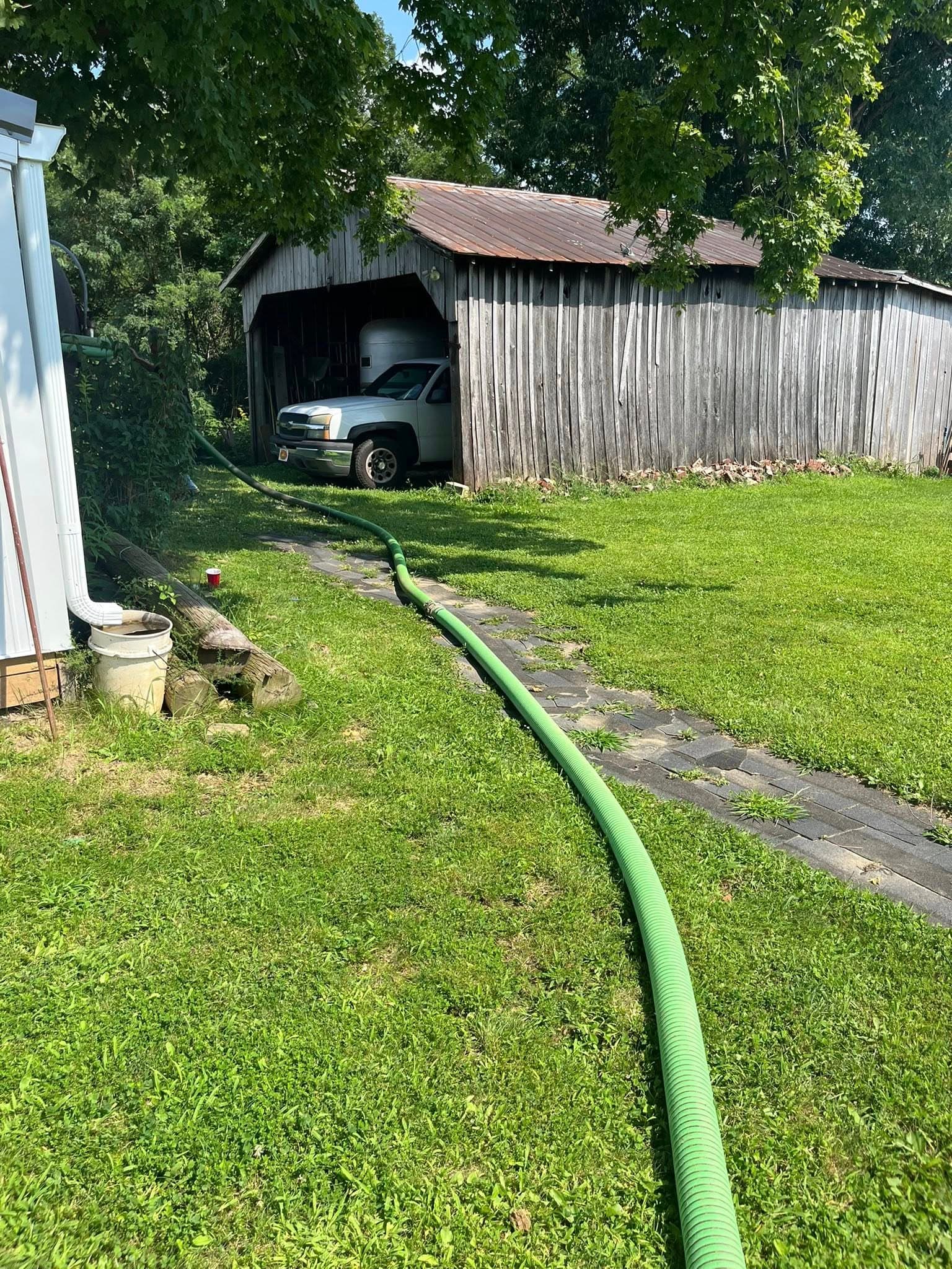 Pump hose running from truck during grease trap cleaning service